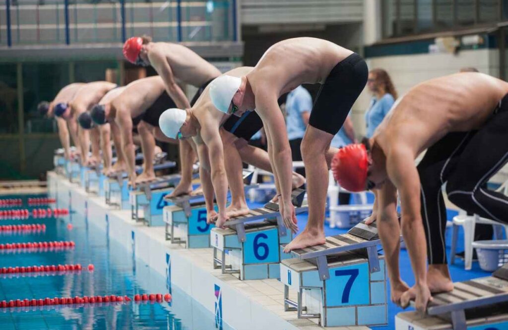 Competitive Swimmers on the blocks ready to race