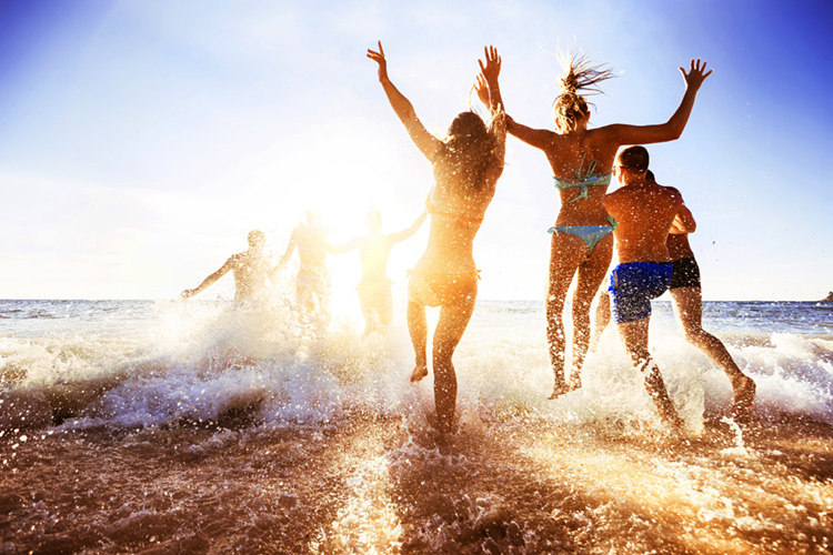 People jumping up in the surf beach