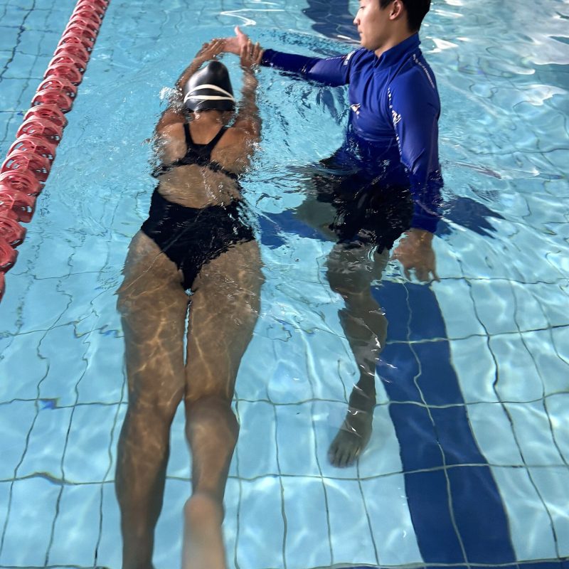 Swimly instructor teaching adult